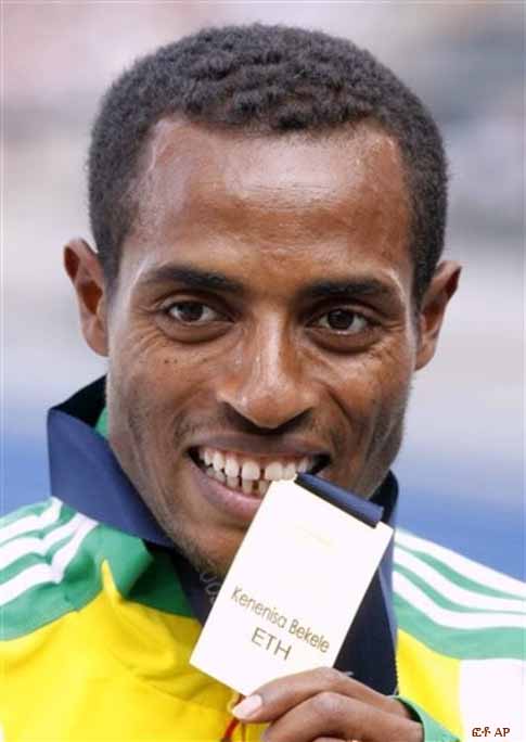 Ethiopia's Kenenisa Bekele bites the gold medal he won in the final of the Men's 5000m during the World Athletics Championships in Berlin on Sunday, Aug. 23, 2009.