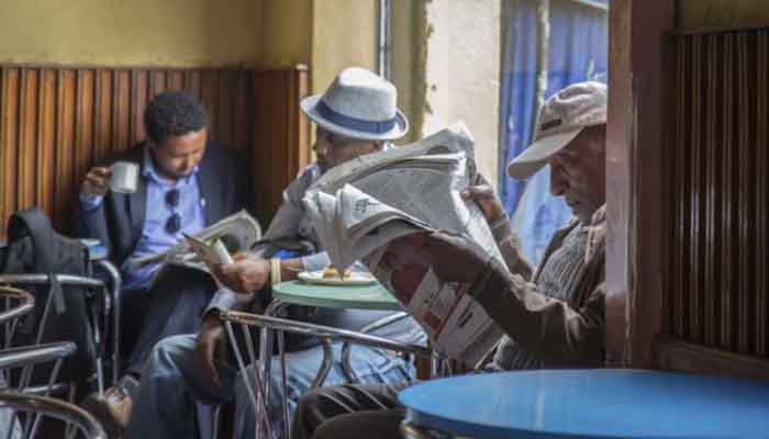 Ethiopian men read newspapers at a cafe in Addis Ababa, Ethiopia on Oct. 10, 2016.