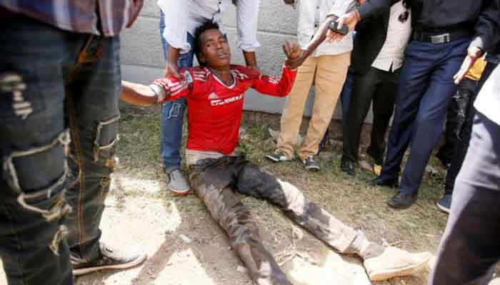 People assist an injured protester during Irrechaa