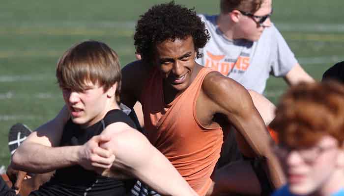 Merhawi Stephen Lake stretches with teammates.